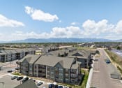 Thumbnail 37 of 38 - an aerial view of an apartment complex with cars parked in a parking lot at Upland Flats, Colorado Springs, CO, 80922