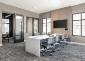 Thumbnail 25 of 38 - a conference room with a large table and chairs and a tv at Upland Flats, Colorado Springs, CO, 80922
