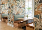 Thumbnail 23 of 61 - A room with a wallpapered wall and a wooden bench at Verity Luxury Apartments, Vero Beach
