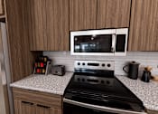 Thumbnail 10 of 13 - A kitchen with a black stove top oven and a microwave above it at Verity Luxury Apartment Homes Apartments, Vero Beach, Florida