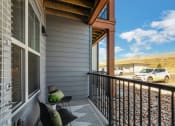 Thumbnail 16 of 38 - a balcony with two chairs and a table  at Upland Flats, Colorado Springs