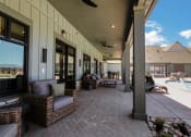 Thumbnail 26 of 38 - a covered patio with wicker furniture and a pool in the background  at Upland Flats, Colorado, 80922