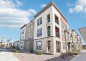 Thumbnail 6 of 108 - an apartment building with a sidewalk in front of it at The Maddox Luxury Apartment Homes, Buckeye Arizona  