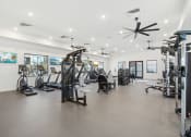 Thumbnail 4 of 108 - a gym with weights and cardio equipment in a building with white walls at The Maddox Luxury Apartment Homes, Buckeye Arizona  