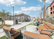 Thumbnail 11 of 108 - a lounge area with couches and chairs and tables at the resort at The Maddox Luxury Apartment Homes, Buckeye, AZ  