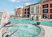 Thumbnail 23 of 108 - our apartments have a large swimming pool with an umbrella at The Maddox Luxury Apartment Homes, Arizona  