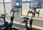 Thumbnail 21 of 56 - a group of exercise bikes in a gym  at Watermark at Steele Crossing, Fayetteville