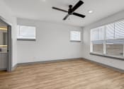 Thumbnail 48 of 58 - a living room with a large window and a ceiling fan at Meridian at CityPlace, Woodbury Minnesota