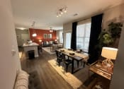 Thumbnail 36 of 56 - an open living room and dining room with a table and chairs at Watermark at Steele Crossing, Fayetteville, AR