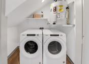 Thumbnail 39 of 45 - a washer and dryer in a laundry room with white walls and wooden floors at The BLVD at Wilson Crossings, Michigan
