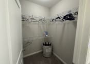 Thumbnail 40 of 56 - a walk in closet with a trash can and hanging racks at Watermark at Steele Crossing, Fayetteville, AR, 72703