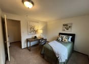 Thumbnail 4 of 15 - a bedroom with a bed and a deskat Holiday Park Apartments, Pennsylvania, 15239