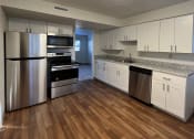 Thumbnail 1 of 15 - a kitchen with white cabinets and a wooden floorat Holiday Park Apartments, Pittsburgh, 15239
