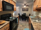 Thumbnail 4 of 36 - Fully Equipped Kitchen and Dining Area at Deauville Park Apartments, Monroeville, PA, 15146