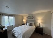 Thumbnail 10 of 36 - a bedroom with a large white bed and a window at Deauville Park Apartments, Monroeville, PA