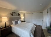Thumbnail 9 of 36 - a bedroom with a large white bed and a closet at Deauville Park Apartments, Monroeville, 15146