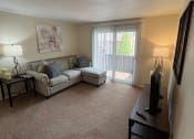 Thumbnail 5 of 36 - a living room with a couch and a tv at Deauville Park Apartments, Monroeville, PA