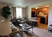Thumbnail 9 of 16 - A living room with a couch, chair, and coffee table.