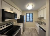 Thumbnail 1 of 36 - a kitchen with stainless steel appliances and white cabinets  at Deauville Park Apartments, Monroeville, PA
