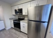 Thumbnail 2 of 36 - a kitchen with stainless steel appliances and white cabinets  at Deauville Park Apartments, Monroeville, 15146