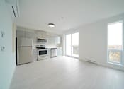 Thumbnail 57 of 77 - Kitchen and Living Area With Modern Finishings at 703 St. Anne's Road Apartments, Winnipeg, MB