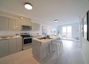 Thumbnail 44 of 77 - Modern Kitchen With Bar Counter at 703 St. Anne's Road Apartments, Winnipeg, MB