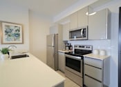 Thumbnail 33 of 77 - Modern Kitchen With Bar Counter at 703 St. Anne's Road Apartments, Winnipeg, MB