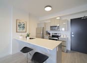 Thumbnail 32 of 77 - Modern Kitchen With Bar Counter at 703 St. Anne's Road Apartments, Winnipeg, MB