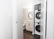 Thumbnail 27 of 33 - a white bathroom with a washer and dryer in it