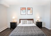 Thumbnail 22 of 33 - a bedroom with a large bed and two night stands with lamps