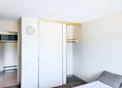 Thumbnail 11 of 13 - A spacious bedroom closet with sliding doors and a view into the hallway at 1025 Munroe Apartments.