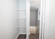 Thumbnail 28 of 33 - a closet in a small room with white walls and a wood floor