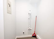 Thumbnail 29 of 33 - a white room with a red broom and a vacuum cleaner