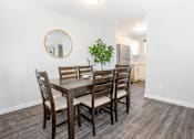 Thumbnail 9 of 33 - a dining room with a table and chairs and a kitchen