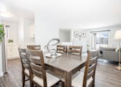 Thumbnail 7 of 33 - a dining room with a wooden table and chairs