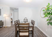 Thumbnail 8 of 33 - a dining room with a wooden table and chairs