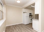 Thumbnail 9 of 40 - A kitchen with white appliances and a window.