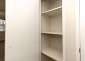 Thumbnail 40 of 40 - A white closet with shelves and a door.