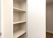 Thumbnail 8 of 40 - Empty white shelves in a white closet.