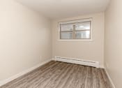 Thumbnail 13 of 40 - A room with a window and a radiator on the floor.