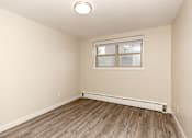 Thumbnail 16 of 40 - A room with a window and a wooden floor.