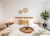 Thumbnail 20 of 36 - A bedroom with a large bed and a tray with a wine glass on it.