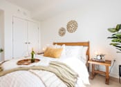 Thumbnail 18 of 36 - A cozy bedroom with a large bed and a tray with a bottle and glasses on it.