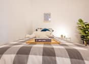 Thumbnail 28 of 36 - A bed with a white teddy bear and a book titled "JED LIND" on it.