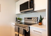Thumbnail 8 of 47 - A modern kitchen with a stainless steel oven and microwave above it.