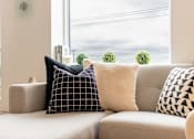 Thumbnail 6 of 47 - A grey couch with four pillows on it.