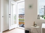 Thumbnail 12 of 47 - A white door opens to a balcony with a view of a street.