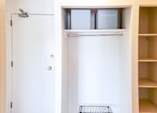 Thumbnail 10 of 13 - Entryway with a built-in closet and shelving for extra storage at 1025 Munroe Apartments.