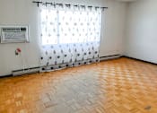 Thumbnail 5 of 13 - Spacious living room with large windows and natural light at 1025 Munroe Apartments.