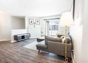 Thumbnail 3 of 33 - a living room with a couch and a floor lamp
